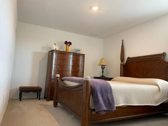 a bedroom with a bed and cabinets