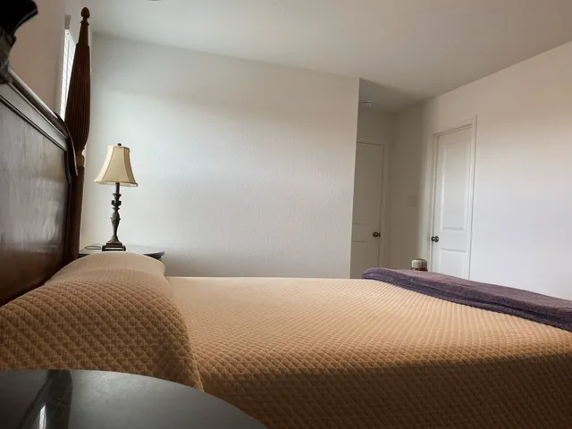 a bedroom with a bed and a flat screen tv