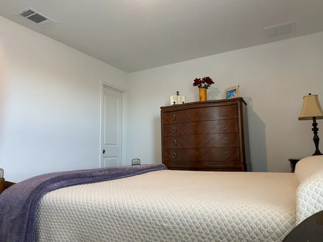 a bedroom with a bed and cabinets