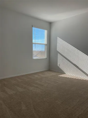 a view of an empty room and closet area