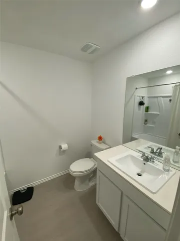 a backyard of a house with dishwasher and wooden fence