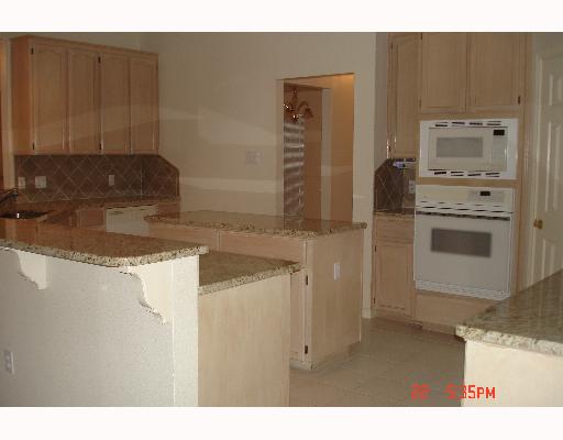 5022 Queen's Court Corpus Christi, TX 78413 - Photo 5 of 9 a kitchen with stainless steel appliances granite countertop a sink stove and refrigerator