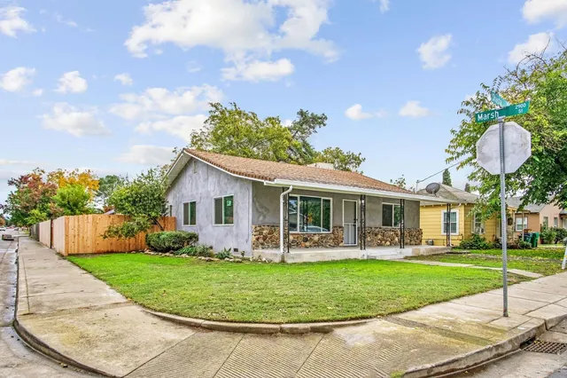 a front view of house with yard and green space