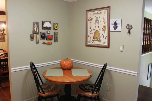 a view of a dining room with a table and chairs