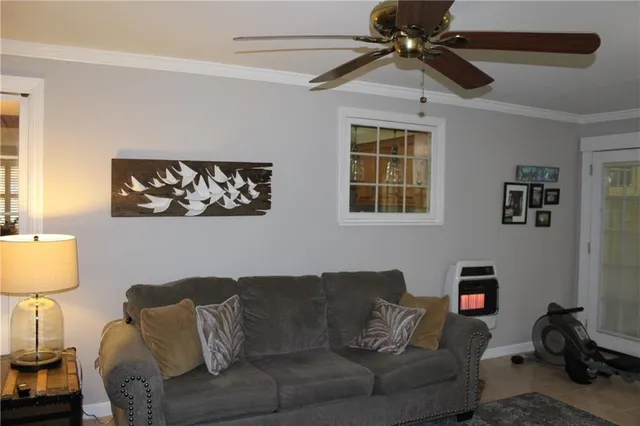 a living room with furniture and a lamp