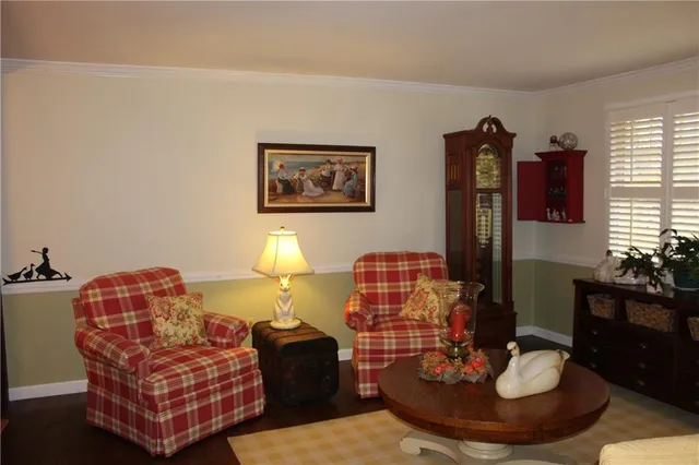 a living room with furniture a rug and a lamp