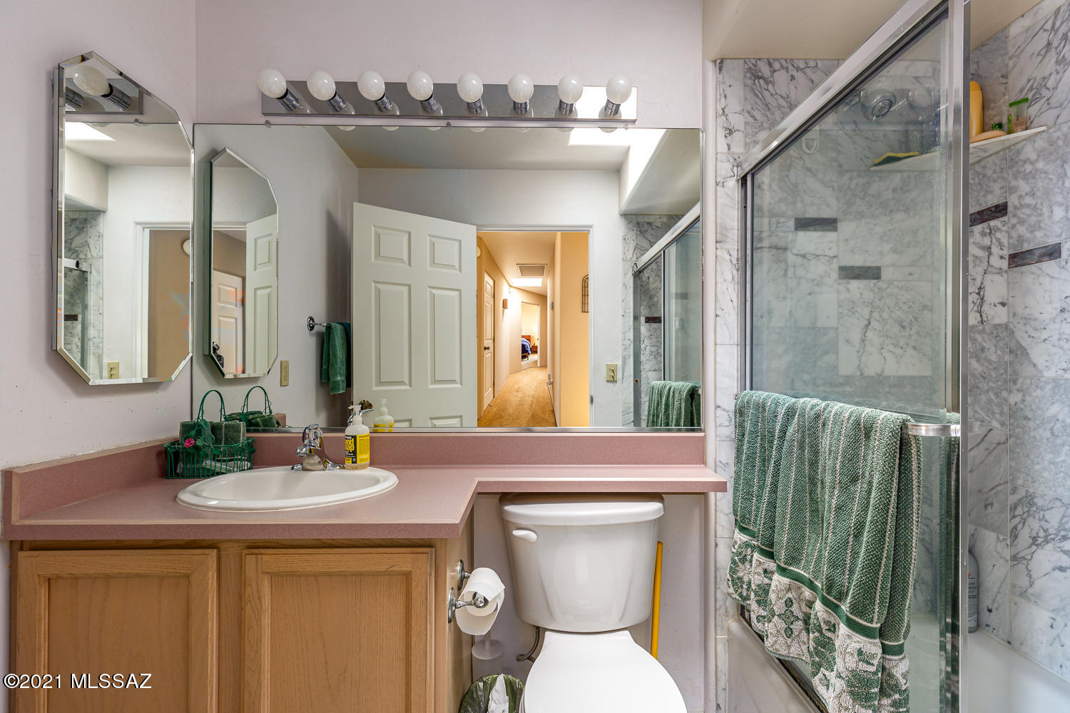 305 East Roger Road Tucson, AZ 85705 - Photo 4 of 15 a bathroom with a toilet sink and mirror