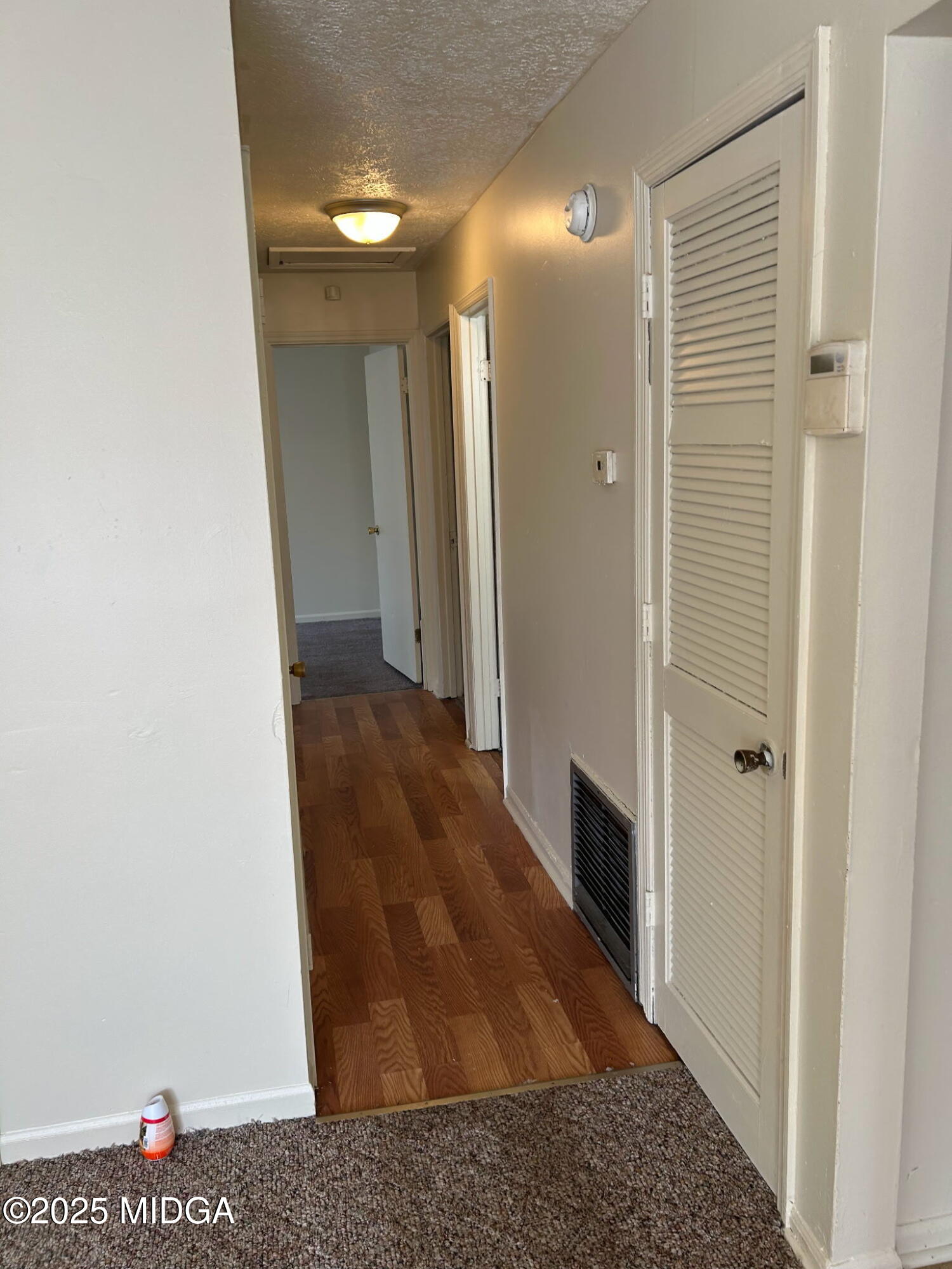 2751 Village Green Lane Macon, GA 31206 - Photo 6 of 10 a view of a hallway with wooden floor and staircase