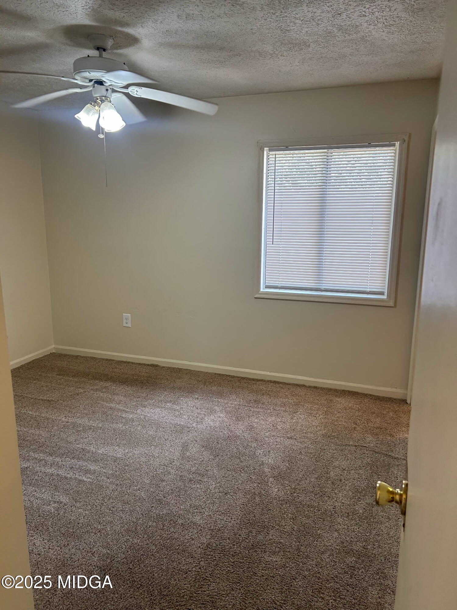 2751 Village Green Lane Macon, GA 31206 - Photo 7 of 10 a view of a room that has a fan and a window