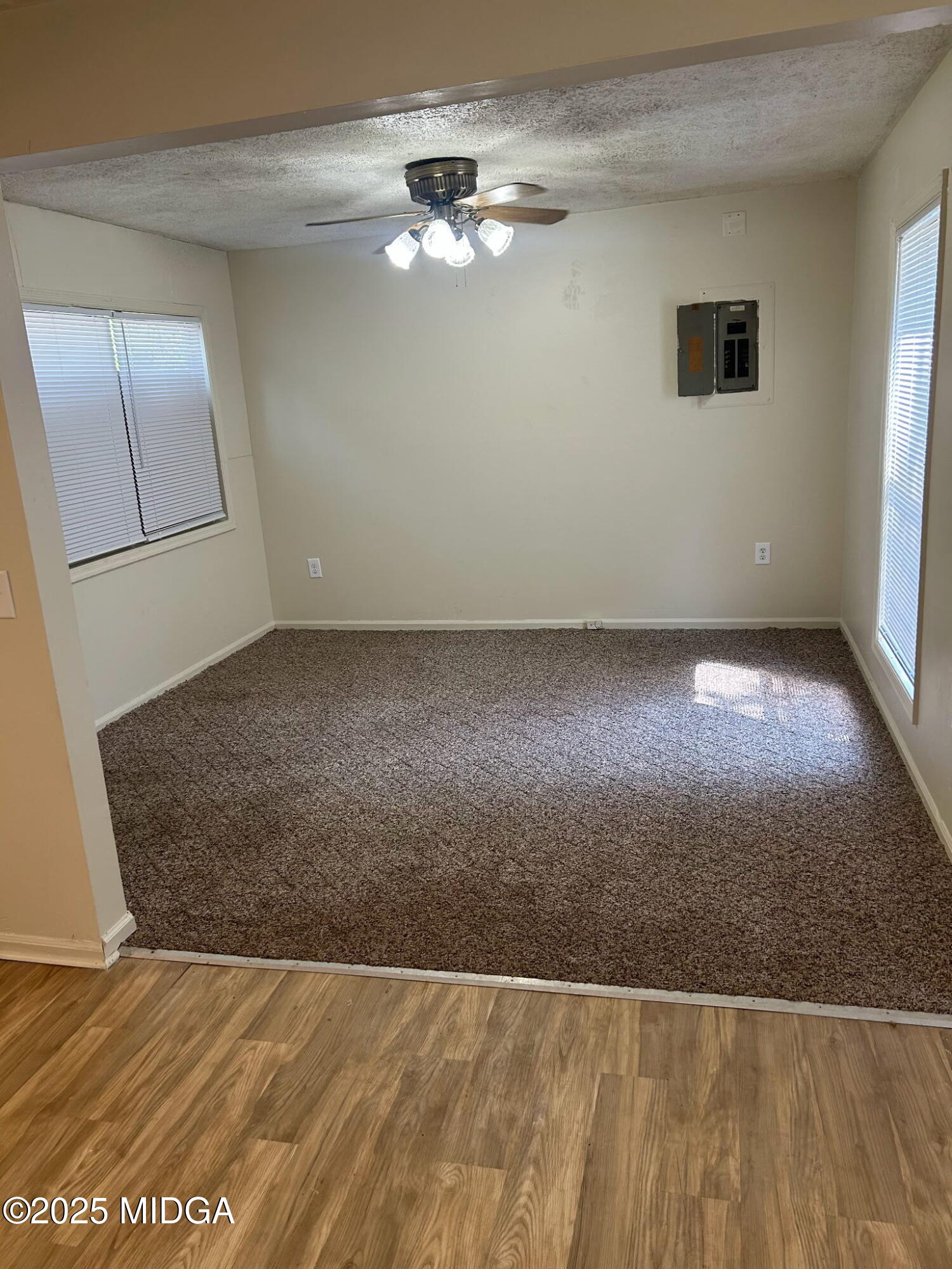 2751 Village Green Lane Macon, GA 31206 - Photo 8 of 10 an empty room with wooden floor and fan