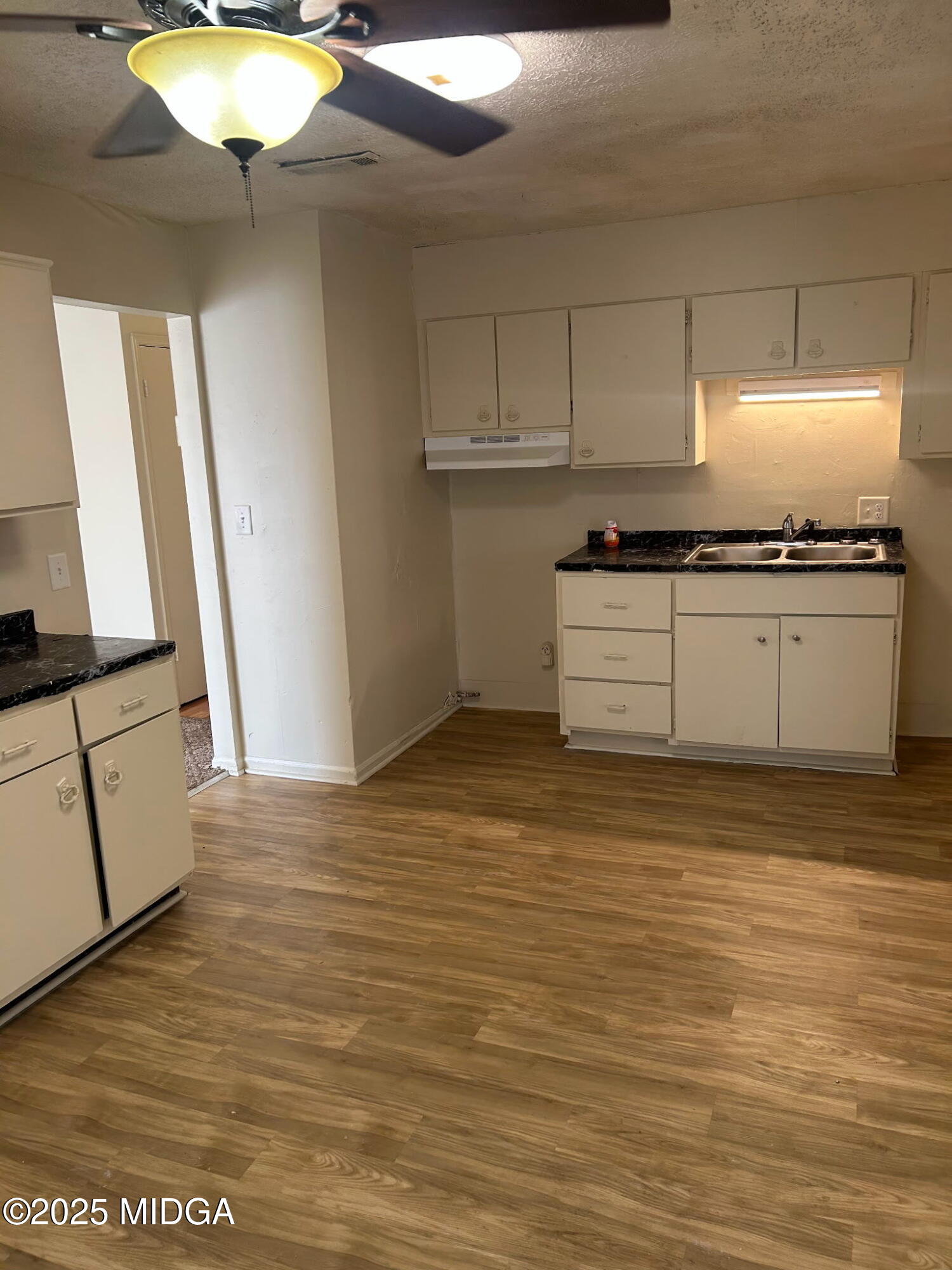 2751 Village Green Lane Macon, GA 31206 - Photo 9 of 10 a kitchen with stainless steel appliances granite countertop a stove a sink and a microwave