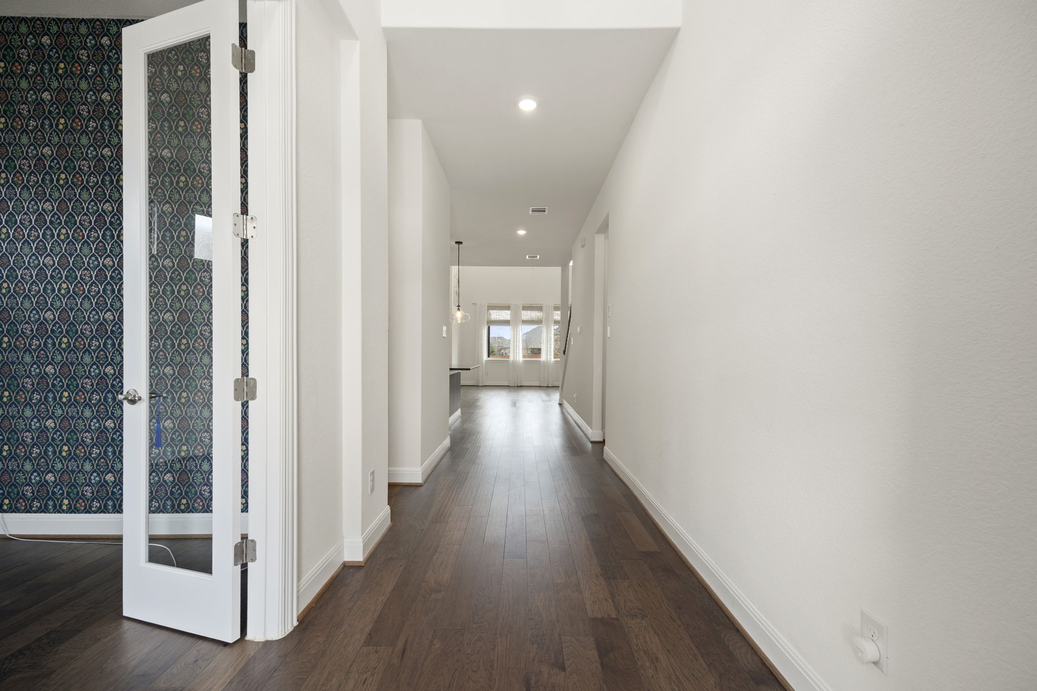 1098 Cherrystone Loop Buda, TX 78610 - Photo 3 of 37 a view of a hallway with wooden floor