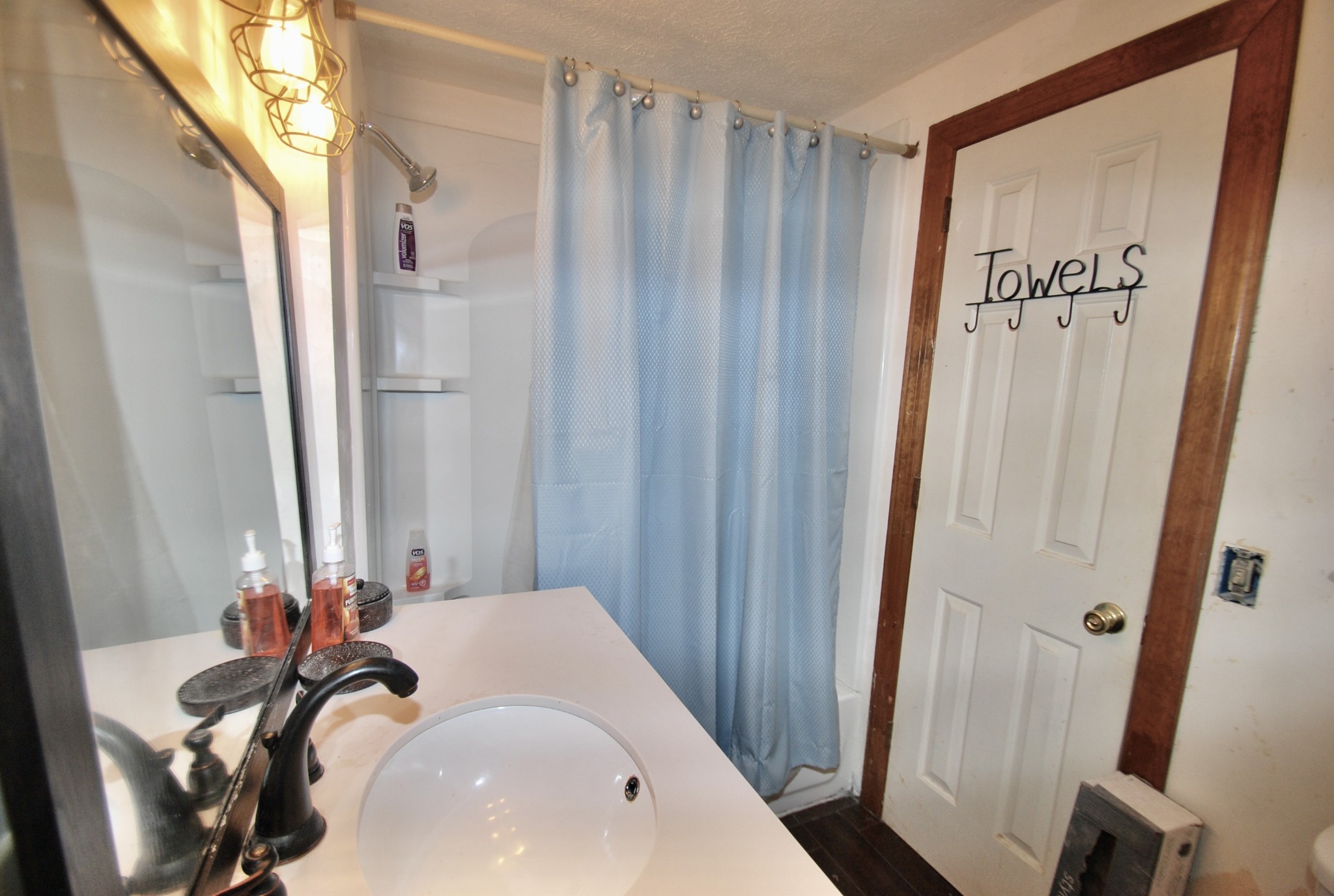 6006 Valley Road Springfield, TN 37172 - Photo 11 of 15 a bathroom with shower a sink and a mirror