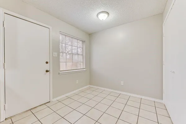 an empty room and chandelier fan