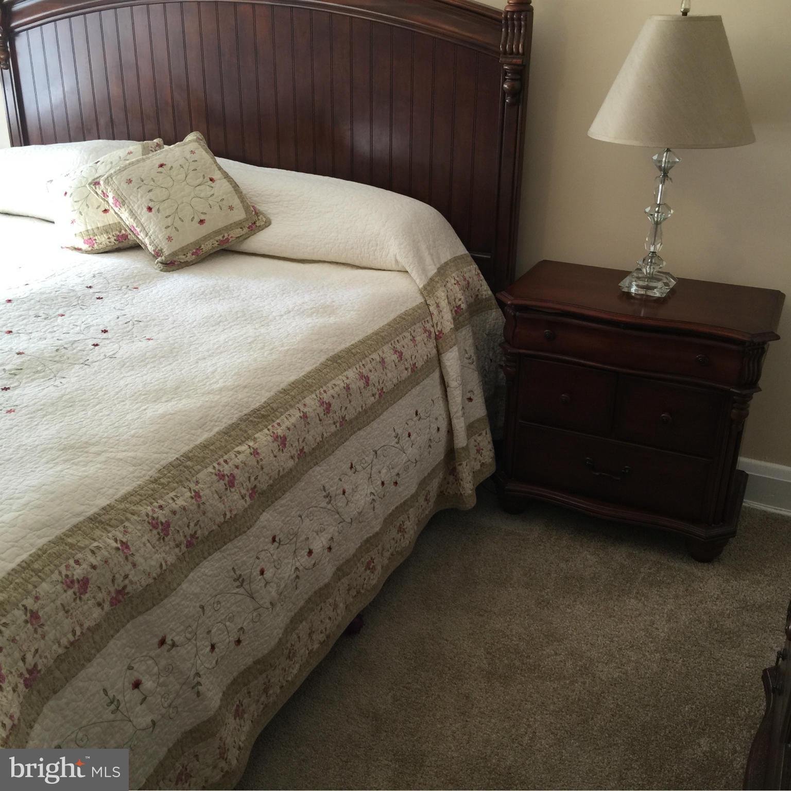 305 Westowne Road Baltimore, MD 21229 - Photo 14 of 30 a bed sitting in a bedroom next to a lamp