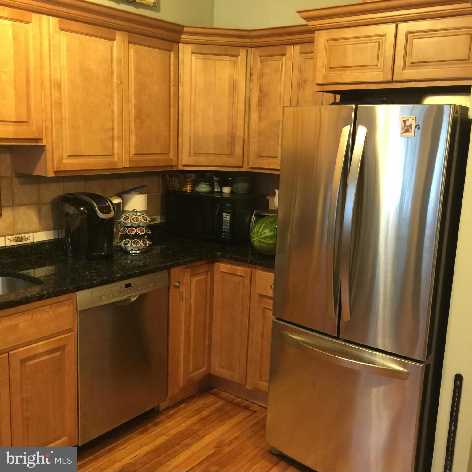 305 Westowne Road Baltimore, MD 21229 - Photo 3 of 30 a kitchen with stainless steel appliances granite countertop a refrigerator and a sink
