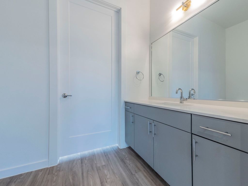 4901 Springdale Road, Unit 103 Austin, TX 78723 - Photo 11 of 26 a bathroom with a sink and a mirror