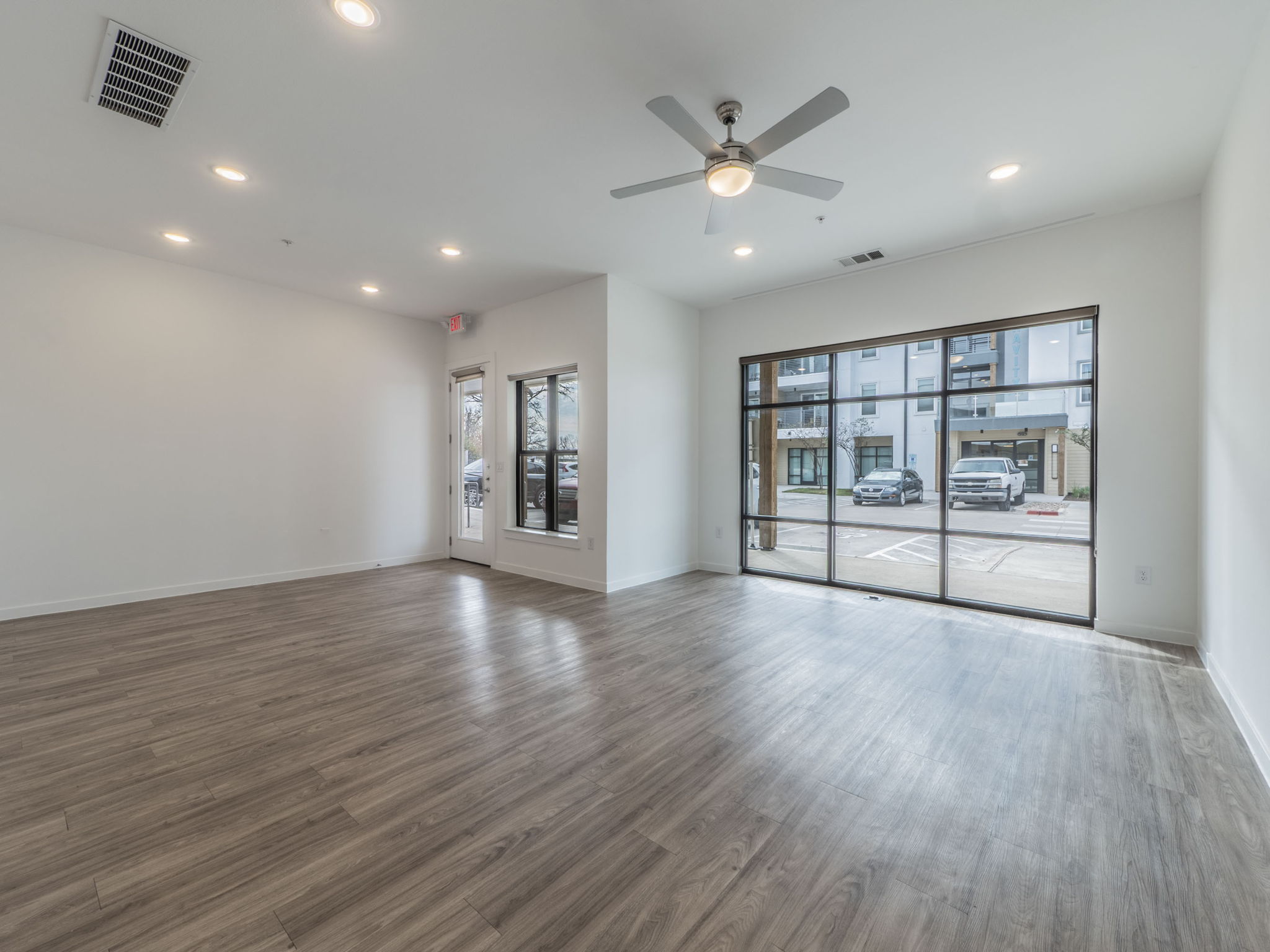 4901 Springdale Road, Unit 103 Austin, TX 78723 - Photo 3 of 26 a view of an empty room with a window and wooden floor