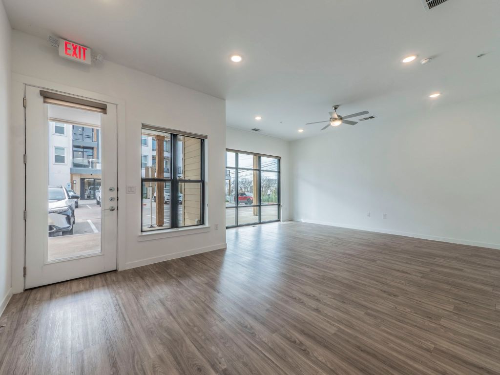 4901 Springdale Road, Unit 103 Austin, TX 78723 - Photo 4 of 26 a view of an empty room with wooden floor and a window