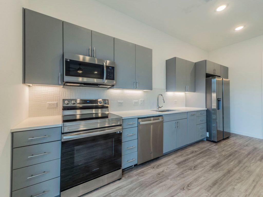 4901 Springdale Road, Unit 103 Austin, TX 78723 - Photo 6 of 26 a kitchen with appliances a sink and cabinets