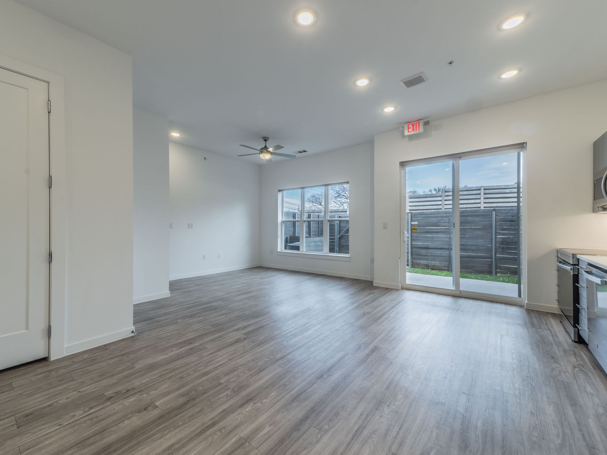 4901 Springdale Road, Unit 103 Austin, TX 78723 - Photo 8 of 26 an empty room with wooden floor and windows