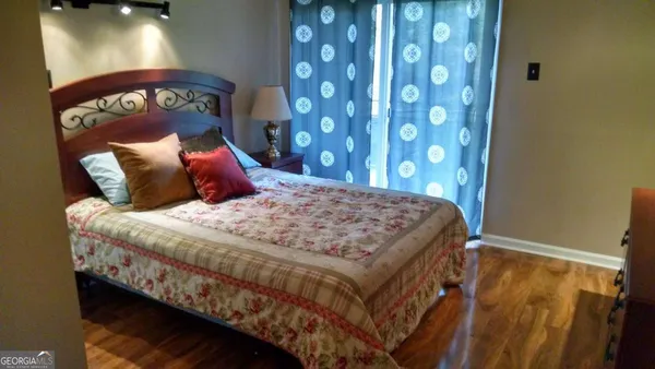 a bed sitting in a bedroom next to a lamp