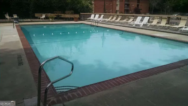 a view of a swimming pool with outdoor seating