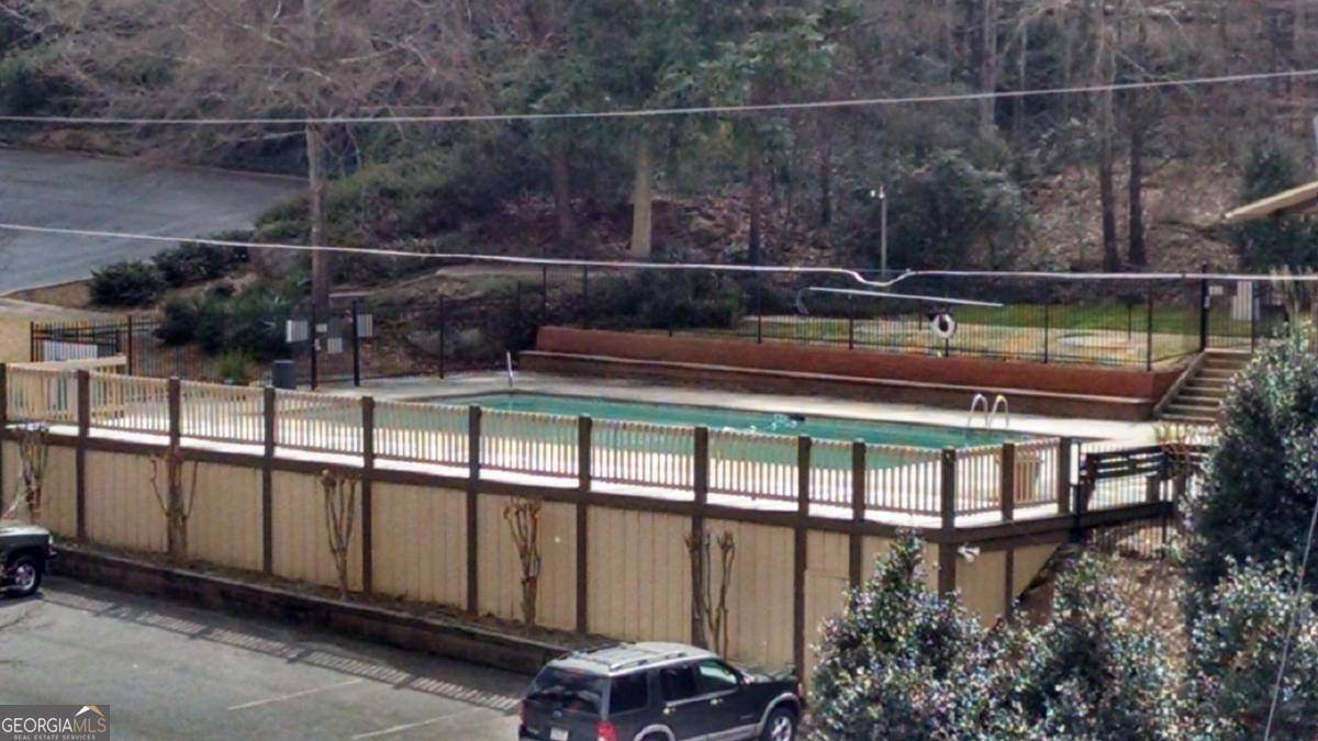 250 Little Street, Unit A301 Athens, GA 30605 - Photo 14 of 15 a view of a chairs and table in the backyard