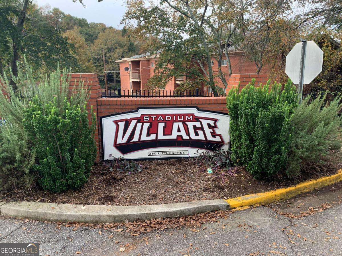 250 Little Street, Unit A301 Athens, GA 30605 - Photo 2 of 15 a sign that is on a brick wall