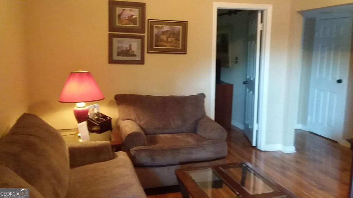 250 Little Street, Unit A301 Athens, GA 30605 - Photo 4 of 15 a living room with furniture and a wooden floor