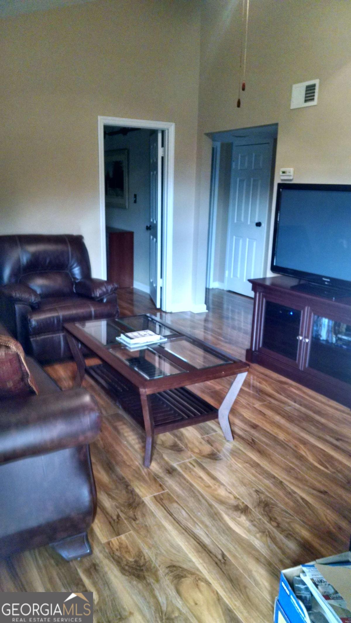 250 Little Street, Unit A301 Athens, GA 30605 - Photo 7 of 15 a living room with couch chairs and a piano