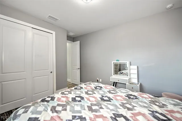 a bedroom with a bed and a dresser