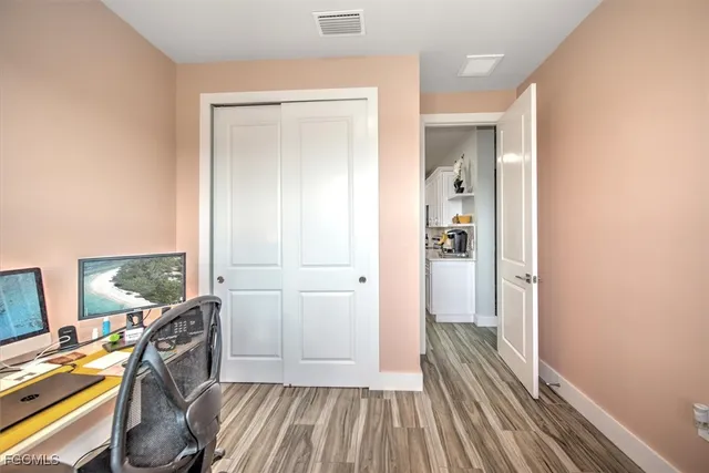a view of a hallway with workspace and living room