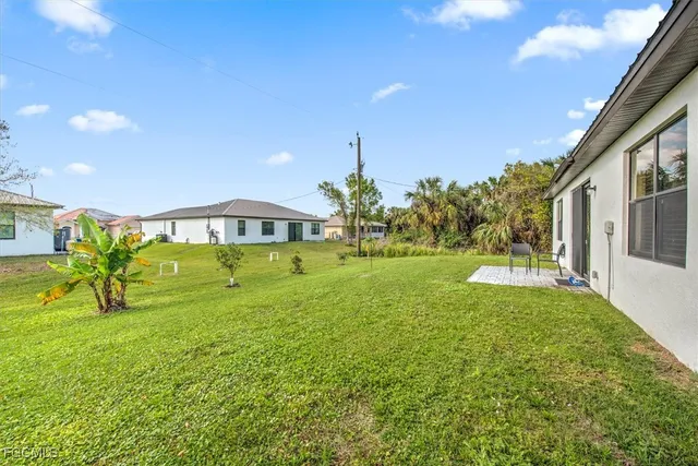 a view of an house with backyard space and balcony