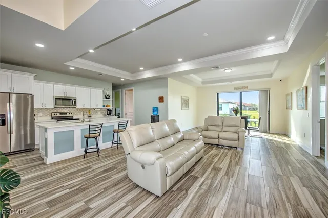 a living room with kitchen island furniture and a wooden floor