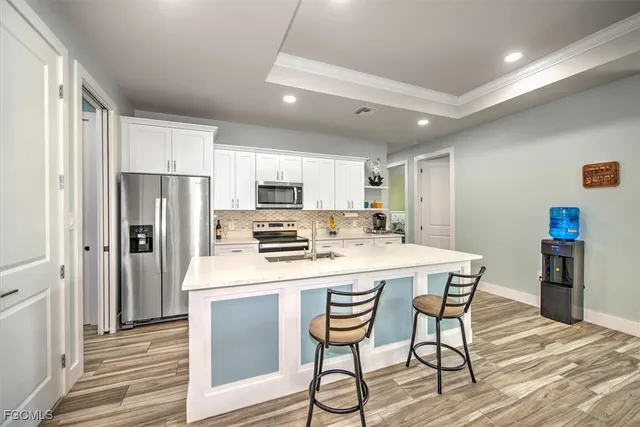 a kitchen with stainless steel appliances a refrigerator and a stove top oven