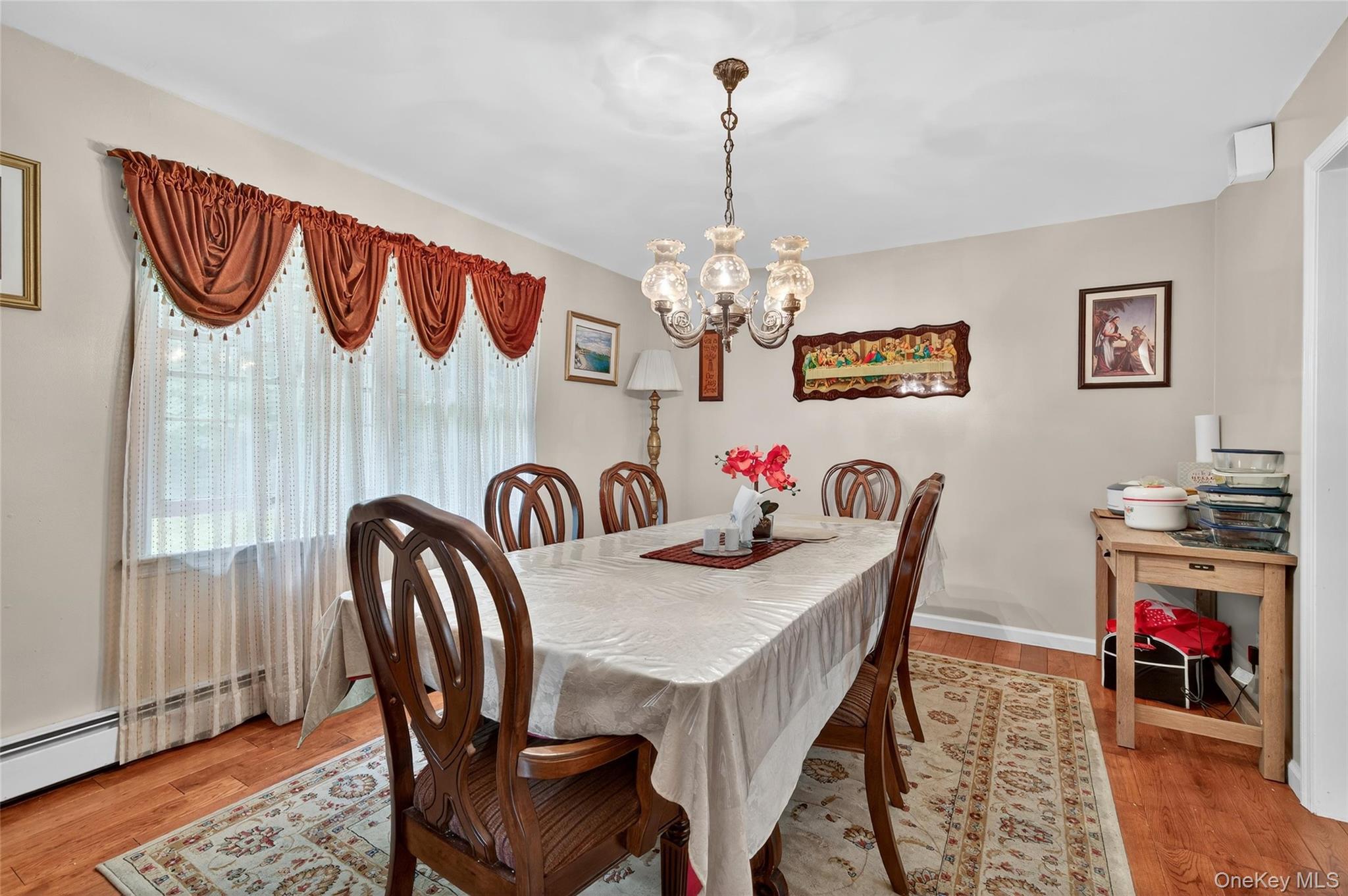 72 Peddler Hill Road Monroe, NY 10950 - Photo 14 of 50 a view of a dining room with furniture wooden floor and chandelier