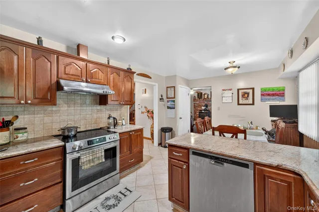 a kitchen with granite countertop a sink stove and cabinets