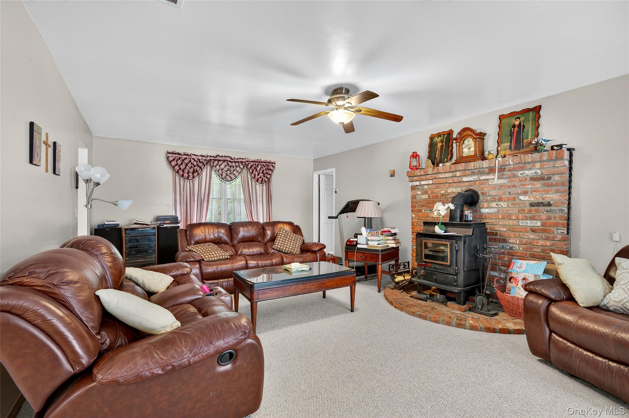 72 Peddler Hill Road Monroe, NY 10950 - Photo 22 of 50 a living room with furniture ceiling fan and a fireplace