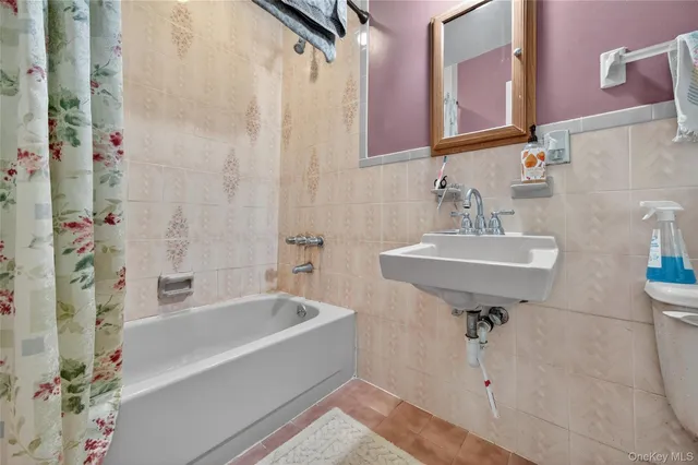 a bathroom with a sink vanity and a mirror