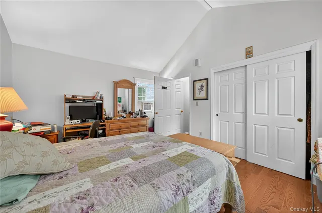 a bedroom with a bed and wooden furniture