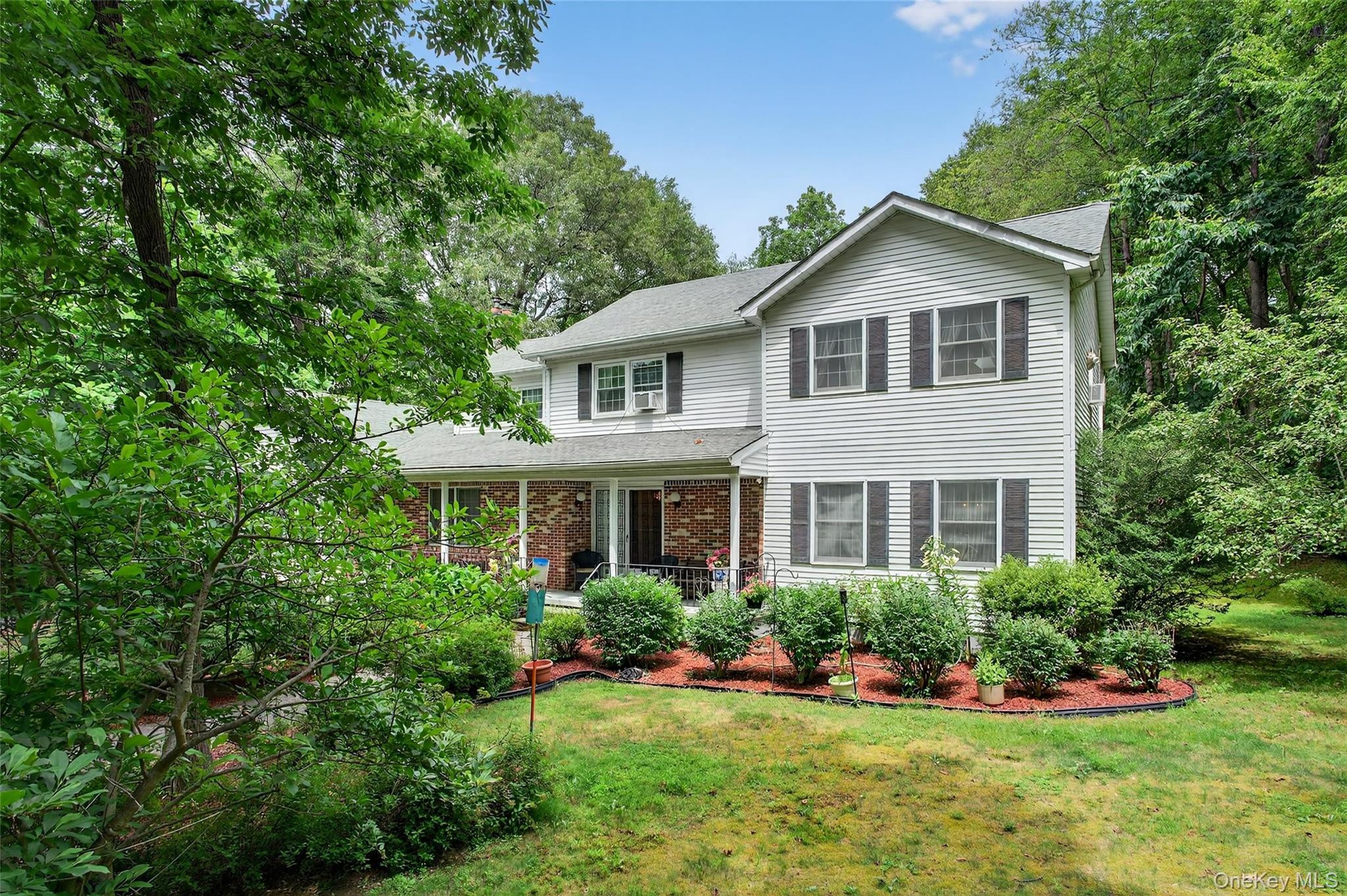 72 Peddler Hill Road Monroe, NY 10950 - Photo 4 of 50 a front view of a house with a yard and trees