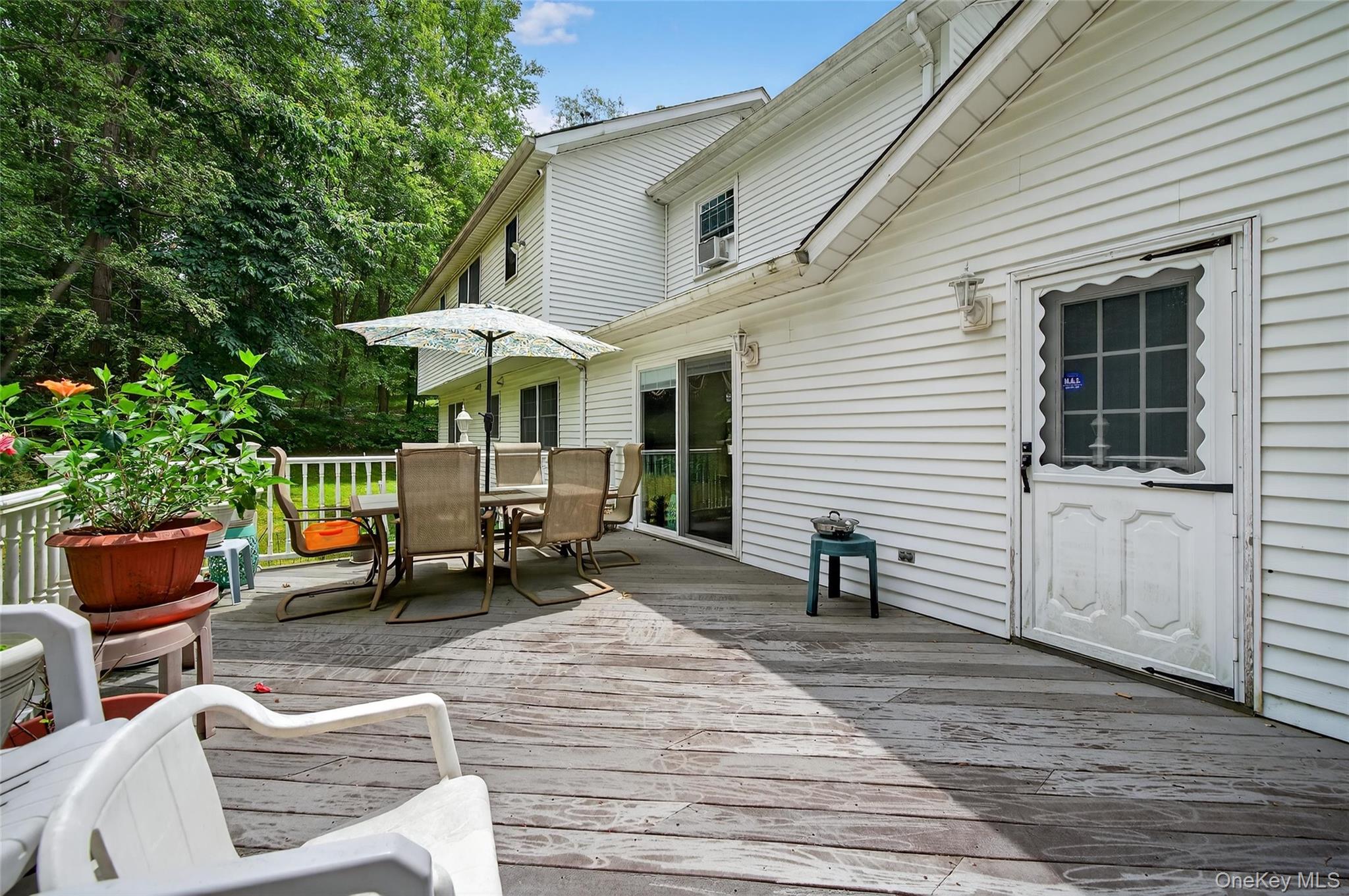 72 Peddler Hill Road Monroe, NY 10950 - Photo 42 of 50 a view of a patio with table and chairs and wooden floor