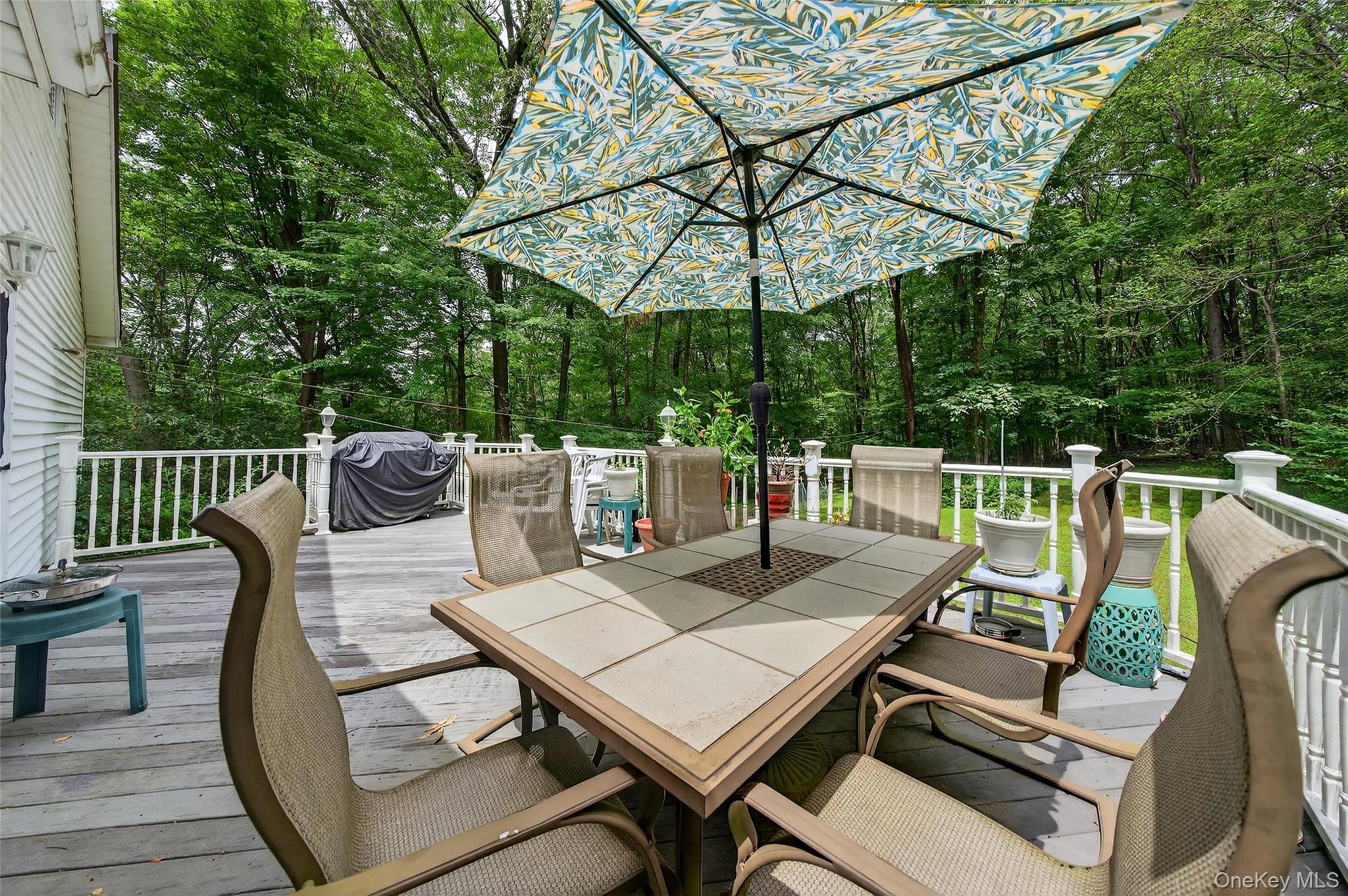 72 Peddler Hill Road Monroe, NY 10950 - Photo 43 of 50 a view of a patio with a table and chairs under an umbrella