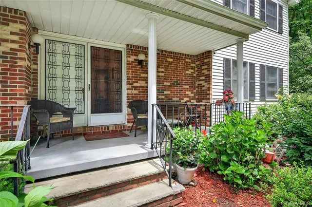 a view of a house with a chairs and table in a patio