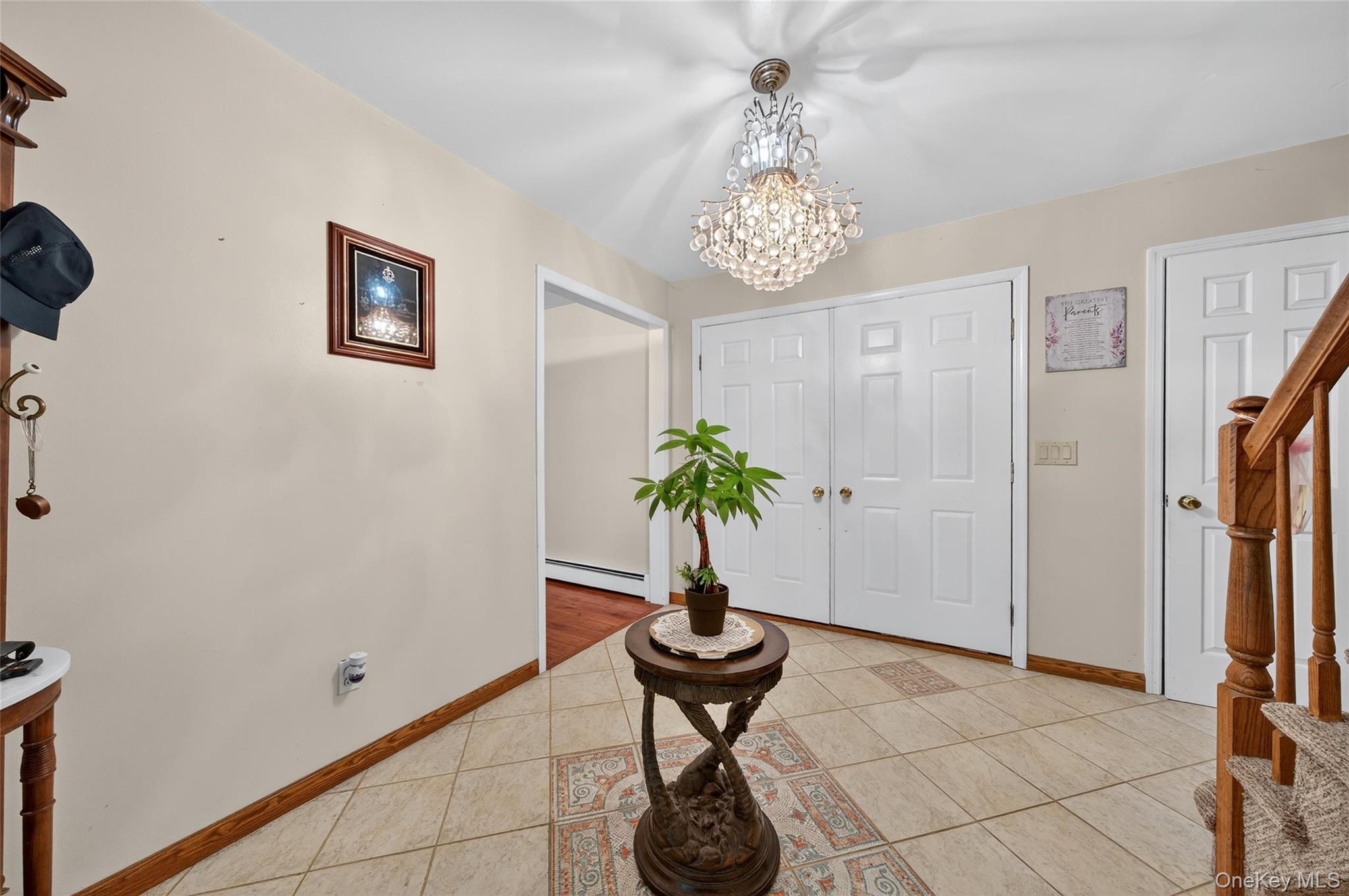 72 Peddler Hill Road Monroe, NY 10950 - Photo 8 of 50 a view of a hallway with chandelier and a vase of flowers