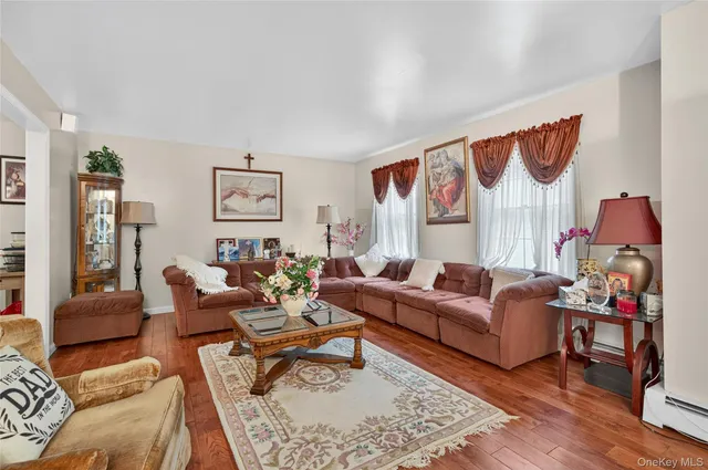 a living room with furniture fireplace and a large window