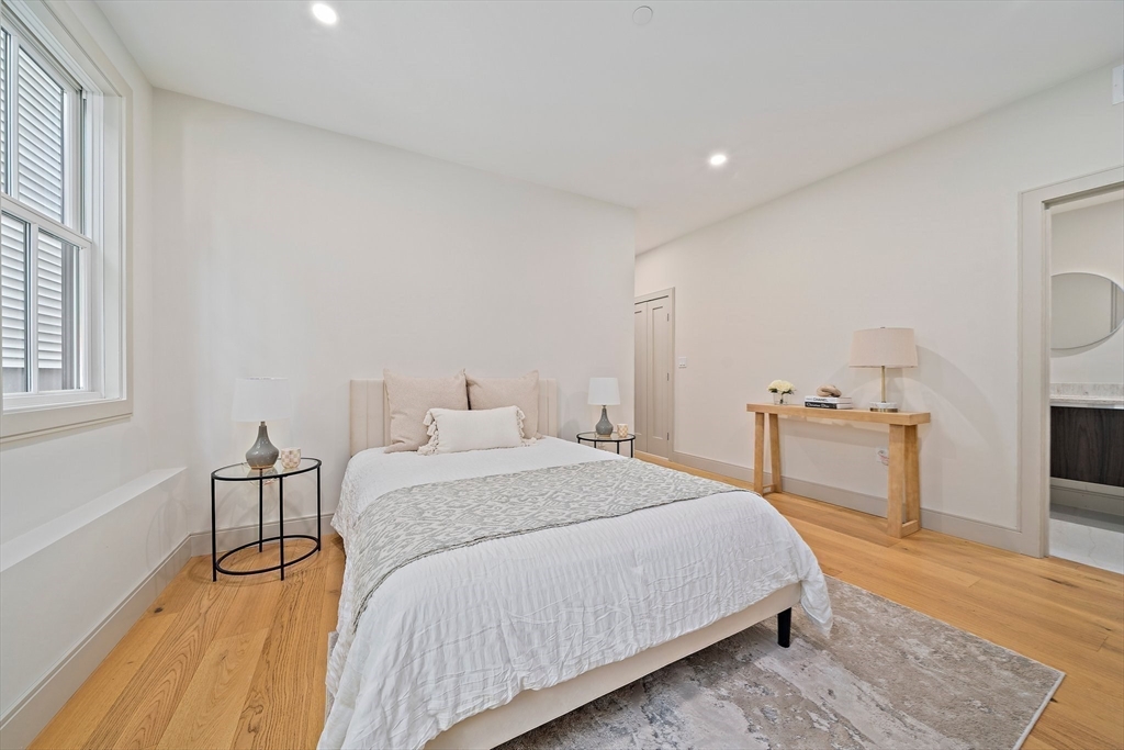 59 Falcon Street, Unit 2 Boston, MA 02128 - Photo 14 of 19 a spacious bedroom with a bed and cabinets