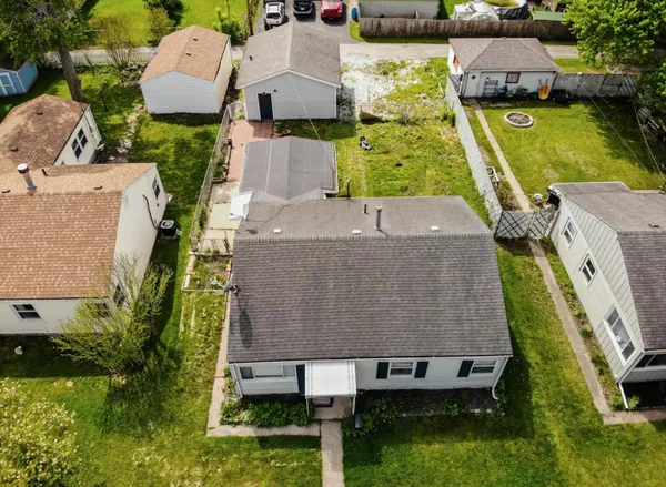 an aerial view of a house with garden space and street view