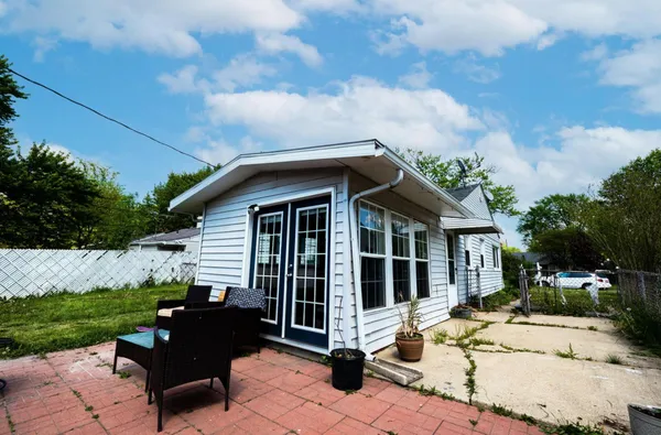 a view of a house with backyard sitting area and garden